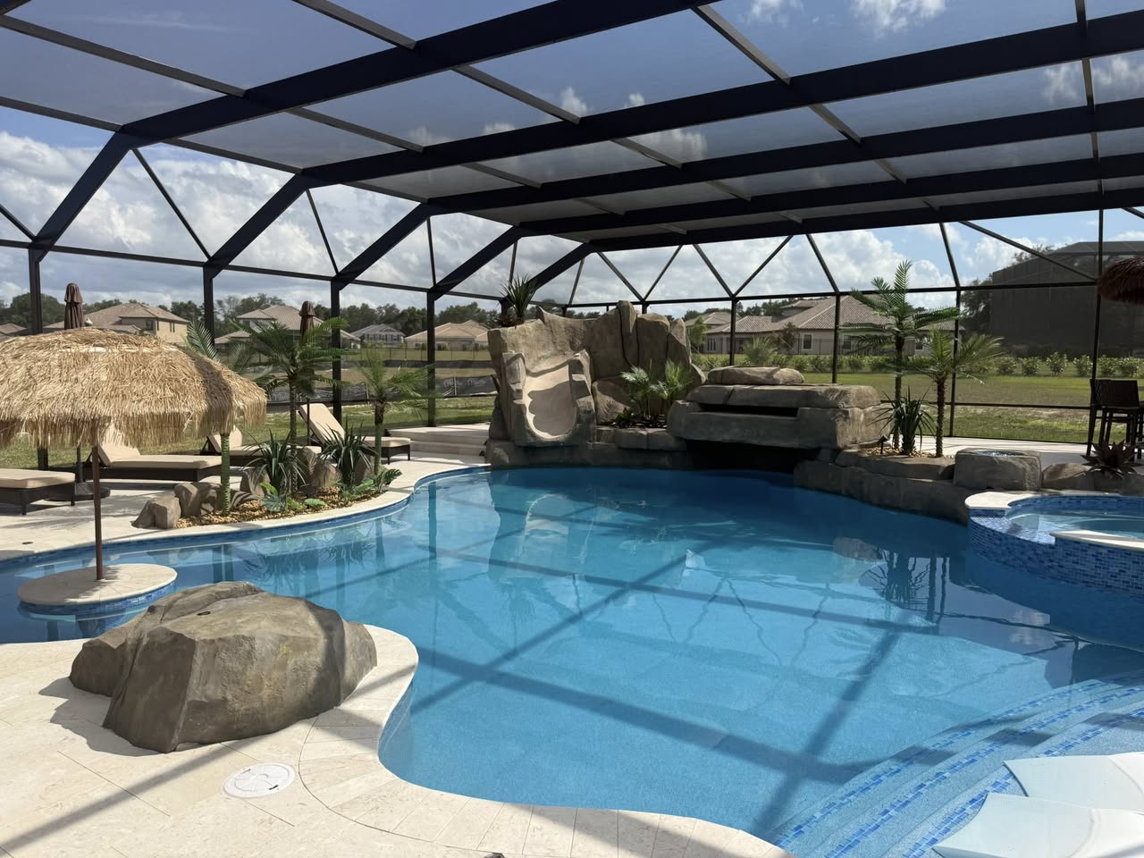 Screened pool enclosure with grotto